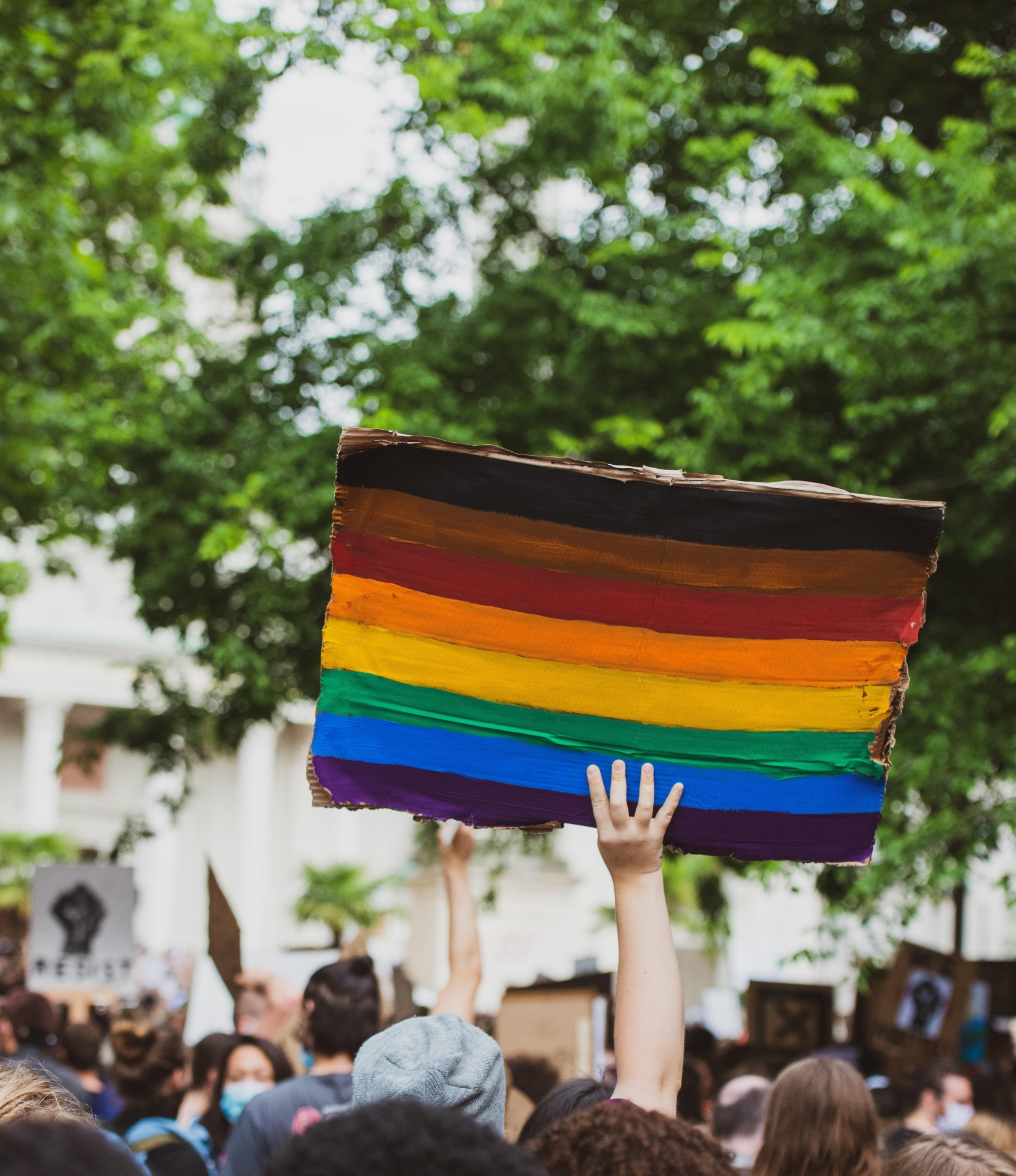 Pride rainbow flag held up in crowd